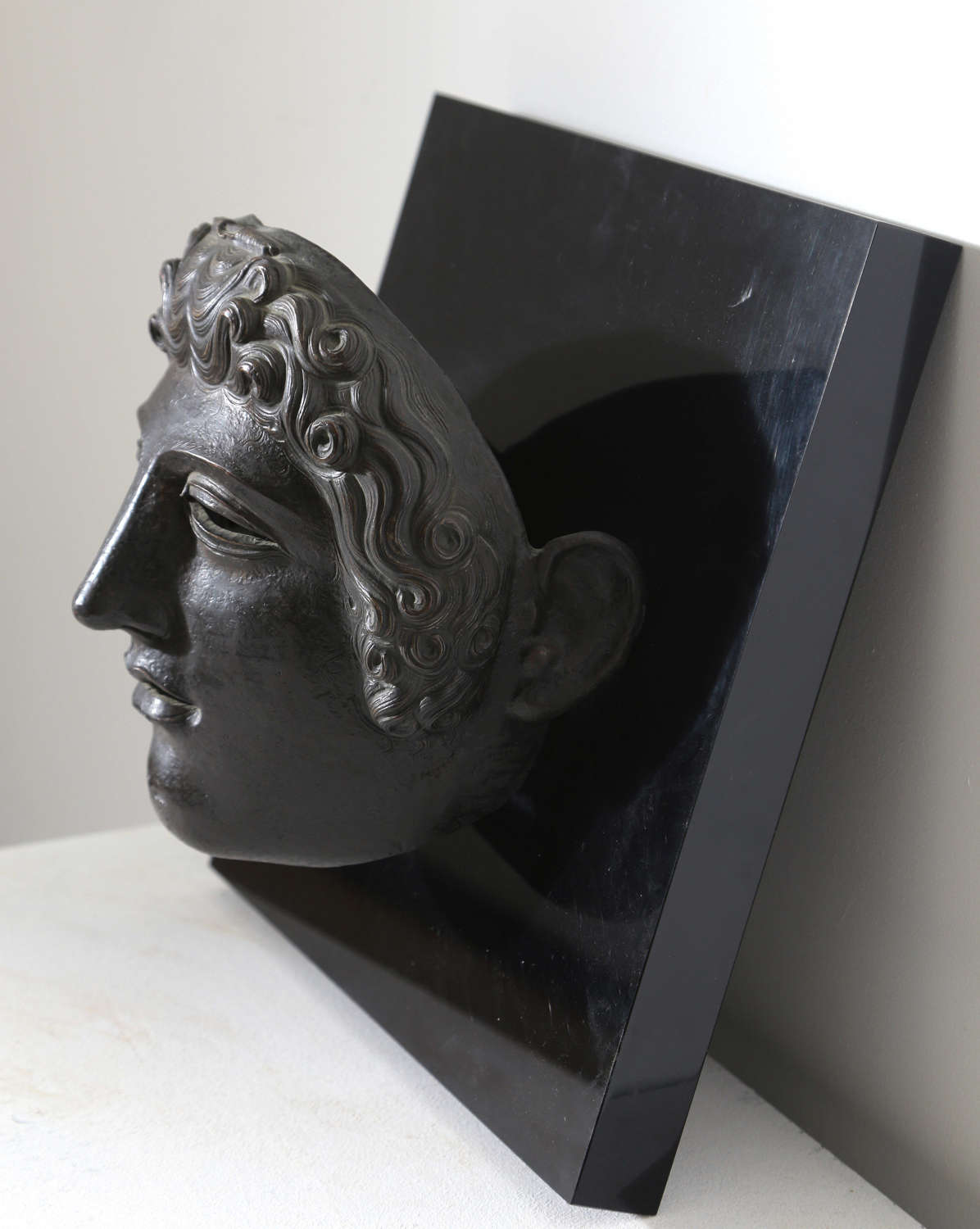 20th century mask of a gladiator mounted on a plaque